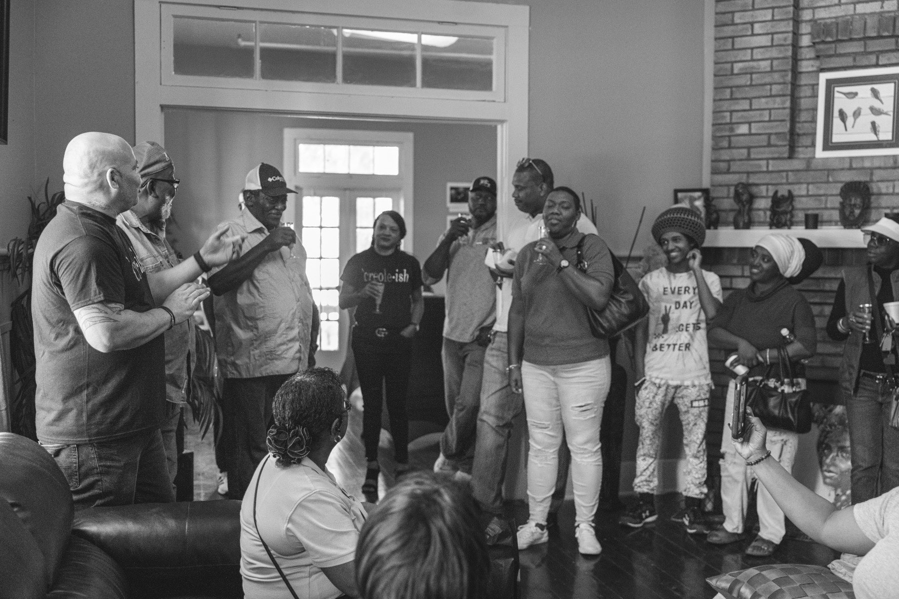 The first Let's Talk, But In French gathering inside a home, people toasting
