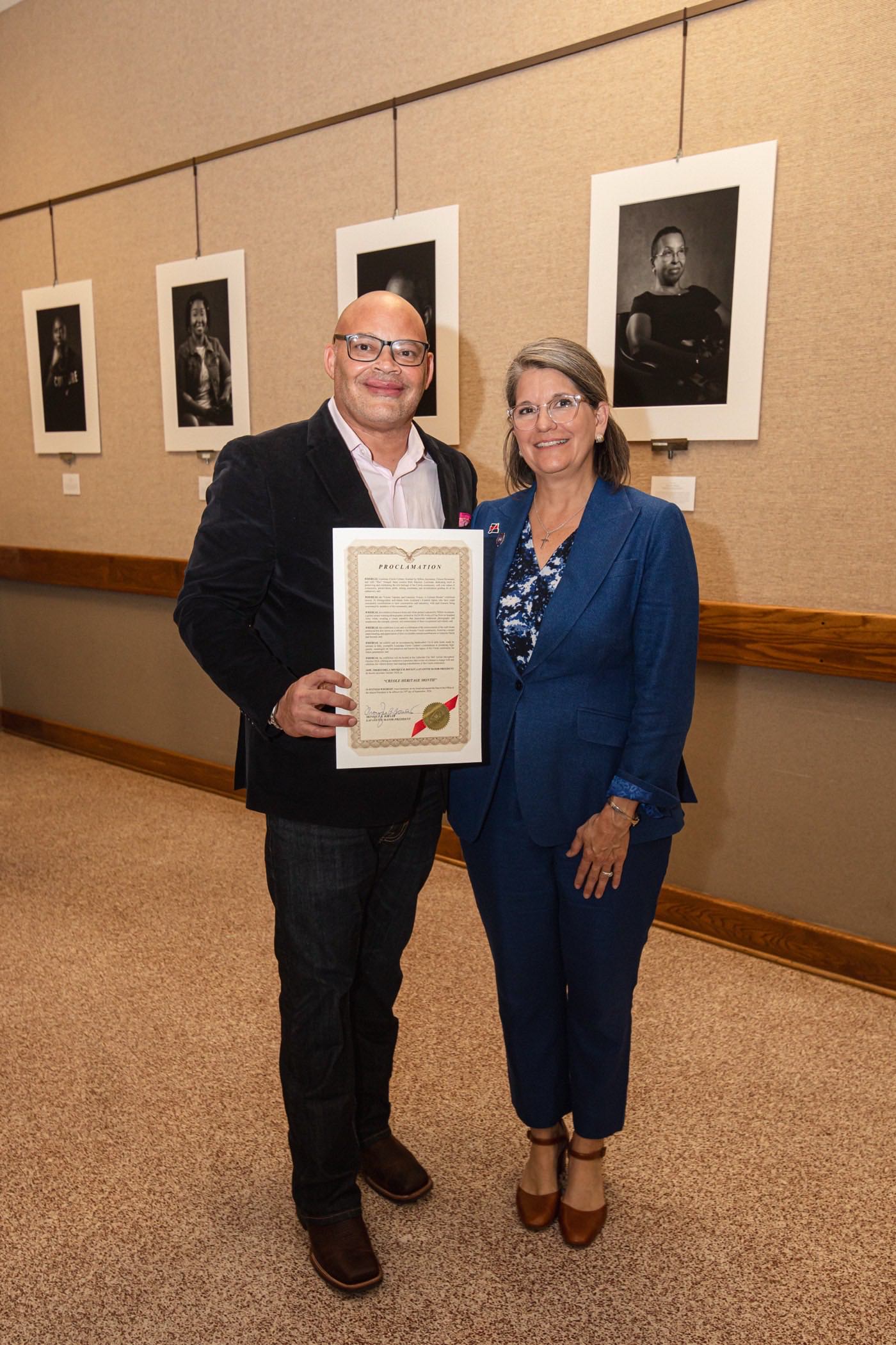 Milton Arceneaux with Lafayette Mayor-President Monique Blanco Boulet holding the Creole Heritage Month proclamation at City Hall